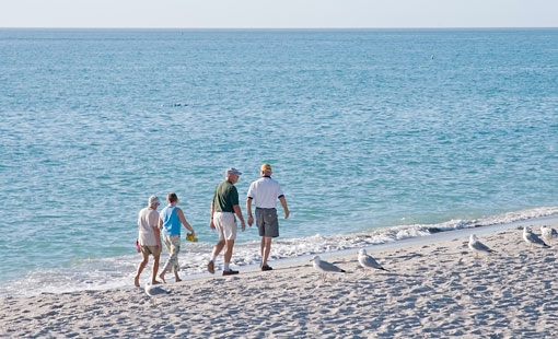 Family on beach for personal insurance